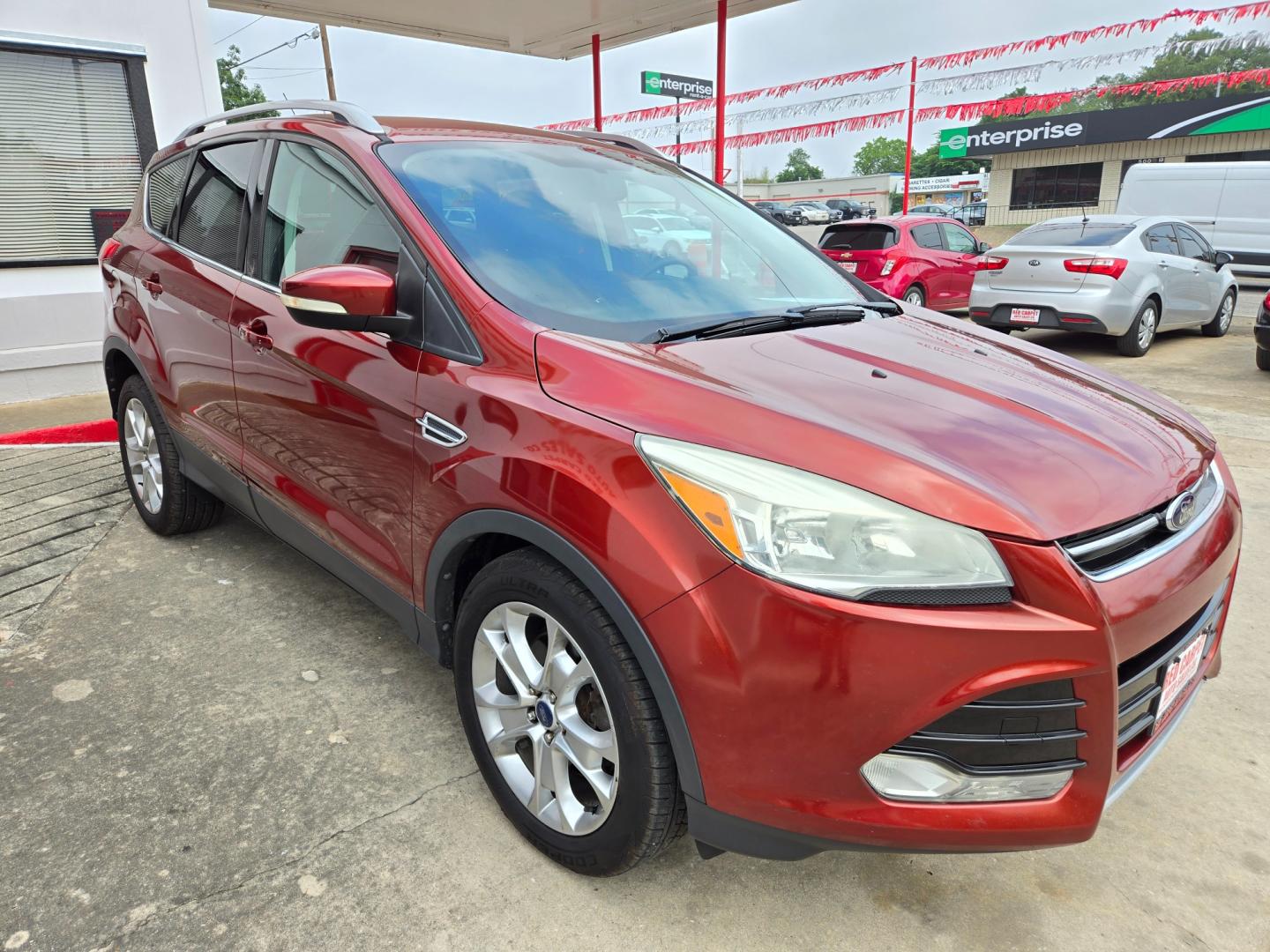 2014 Orange Ford Escape Titanium 4WD (1FMCU9JX7EU) with an 1.6L L4 DOHC 16V engine, 6-Speed Automatic transmission, located at 503 West Court, Seguin, TX, 78155, (830) 379-3373, 29.568621, -97.969803 - Photo#1